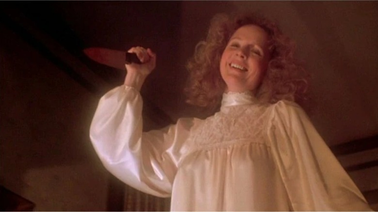 Margaret White (Piper Laurie), holding a knife in the air as she chases her daughter