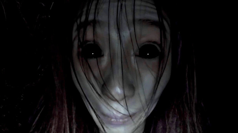 Freaky black-eyed woman stares.