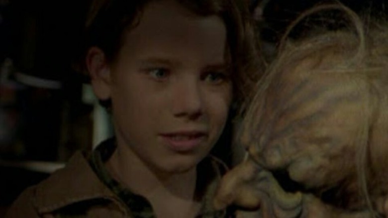 Steve Boswell (John White) examines a creepy mask in Goosebumps (1995)