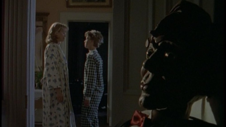 Trina (Erica Fairfield) and Dan (Blair Slater) speak in pajamas with Slappy (Cal Dodd) in the foreground in Goosebumps (1995)