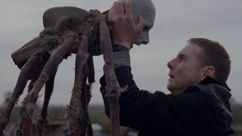 Possum's Sean Harris holding spider puppet
