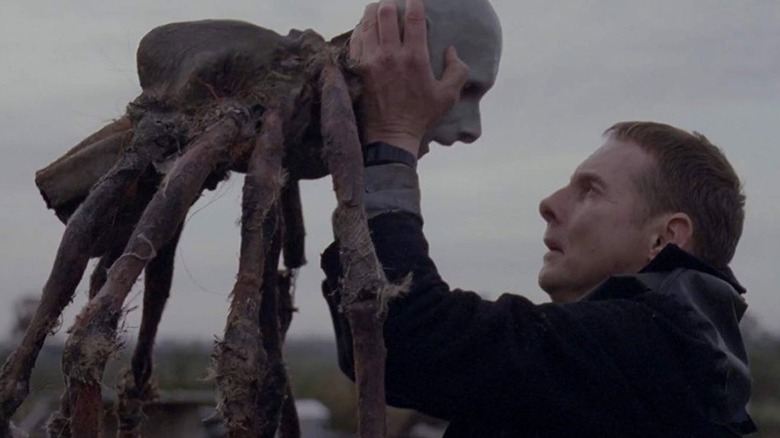Possum's Sean Harris holding spider puppet