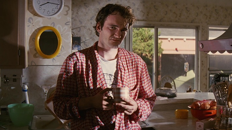 Quentin Tarantino holding coffee mug