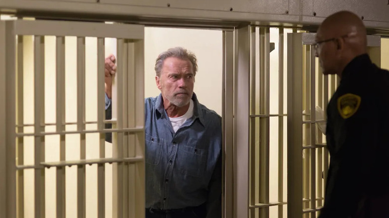 Roman Melnyk (Arnold Schwarzenegger) glares at a prison guard from his cell in Aftermath (2017)