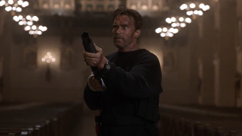 Jericho Cane (Arnold Schwarzenegger) aims a shotgun in a church in End of Days