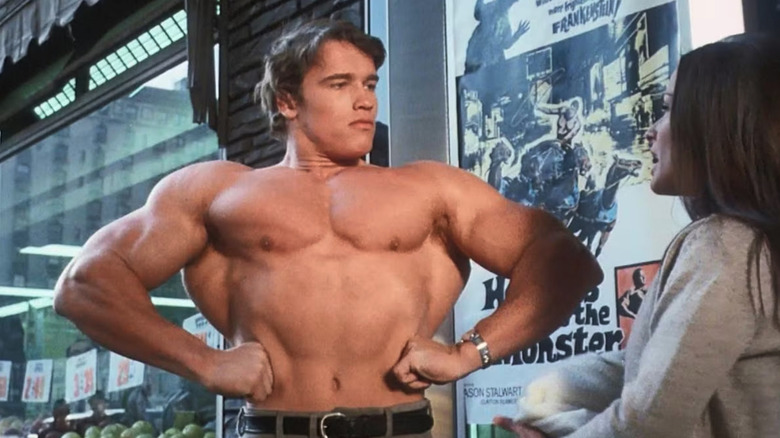 Hercules (Arnold Schwarzenegger) shows off his muscles to a woman in Hercules in New York