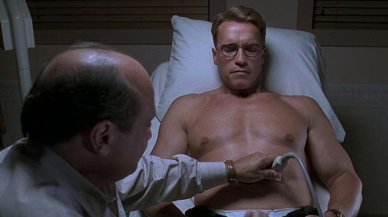 Larry Arbogast (Danny DeVito) does an ultrasound on Alex Hesse (Arnold Schwarzenegger) in Junior (1994)