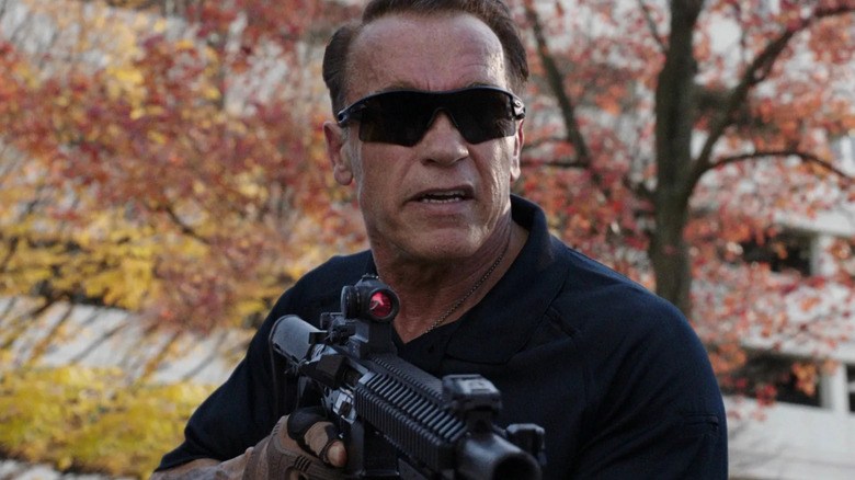 Breacher Wharton (Arnold Schwarzenegger) looks up while holding an assault rifle in Sabotage (2014)