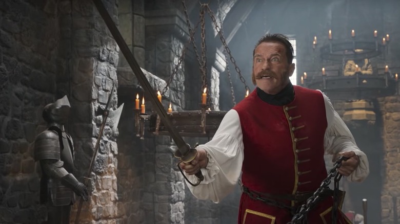 James Hook (Arnold Schwarzenegger) holds a cutlass and chains in Iron Mask