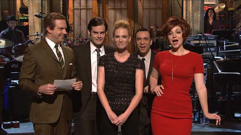 January Jones surrounded by SNL cast members while giving her monologue