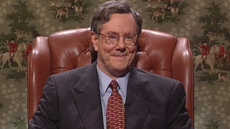 Steve Forbes sitting in a chair smiling on Saturday Night Live