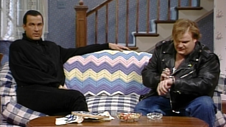 Steven Seagal sitting on a couch with Chris Farley on Saturday Night Live