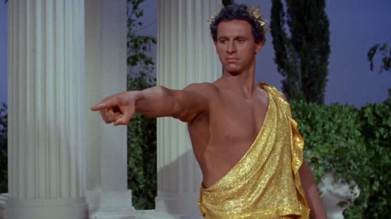 Apollo (Michael Forest) points menacingly whilst in gilded toga on Star Trek the Original Series