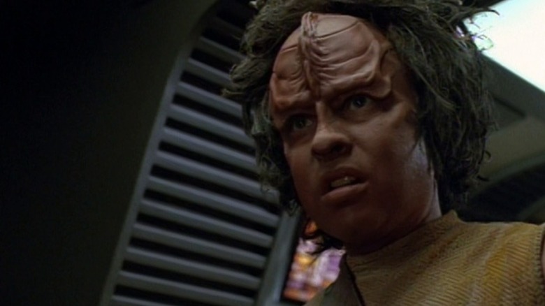 A young, dark-skinned Kazon looks pensive on Star Trek: Voyager