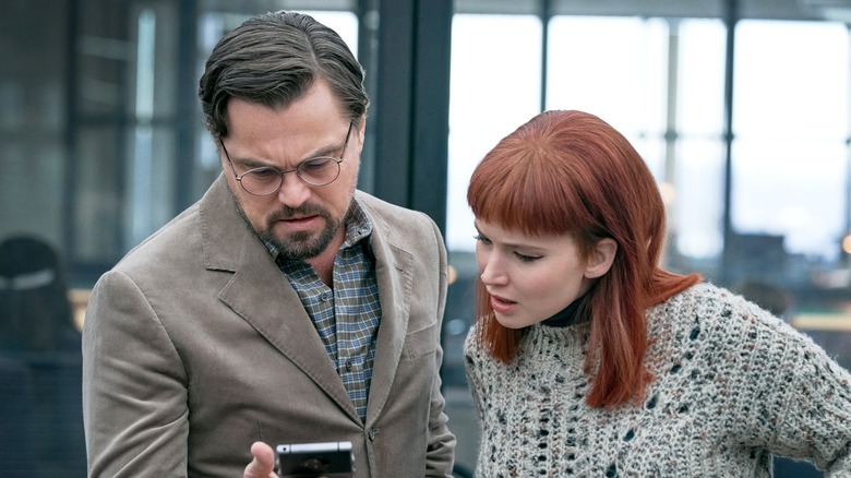 Leonardo DiCaprio and Jennifer Lawrence stare at phone