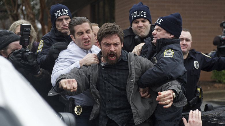 Keller Dover being held back by police