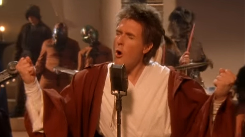 Weird Al Yankovic dressed as Obi-Wan Kenobi singing The Saga Begins