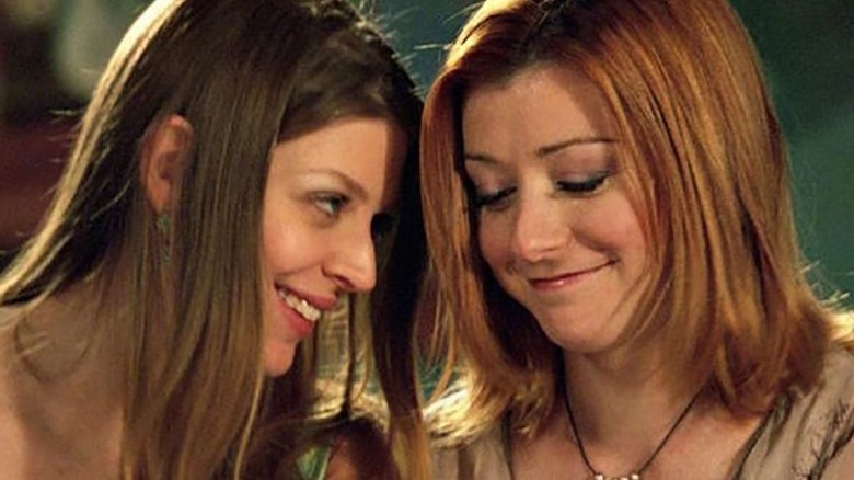 Willow and Tara smiling with heads close