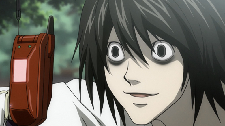 L smiles at a cell phone