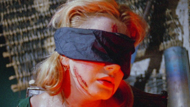 Woman bloody and blindfolded in Blood and Black Lace