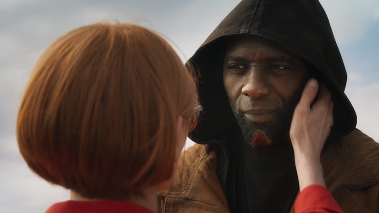 Tilda Swinton touching Idris Elba