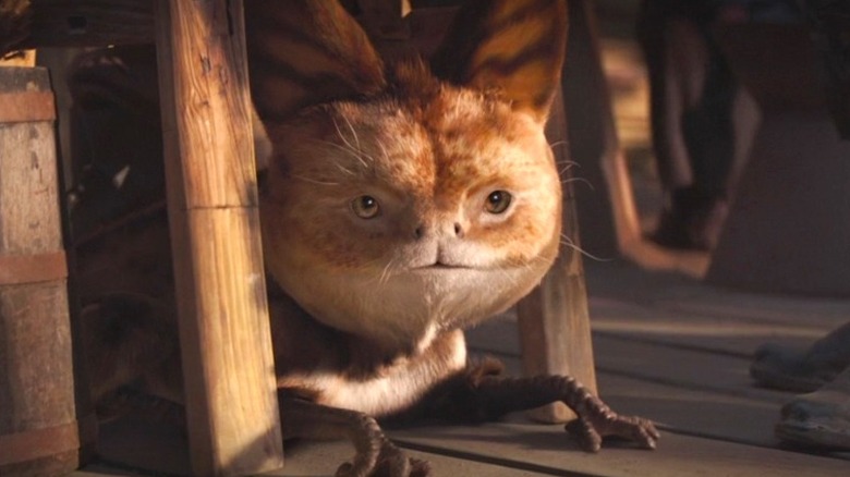 A Loth-cat considers Grogu as a snack