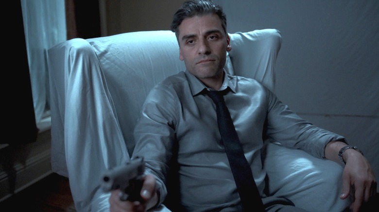 Oscar Isaac points gun