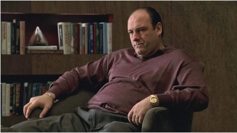 Tony Soprano sitting and frowning