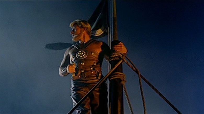 Man holding on to the mast of a ship