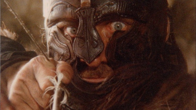 Viking in helmet pulls bowstring