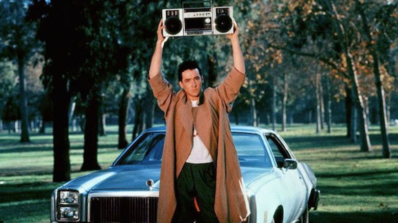 John Cusack stands with boombox