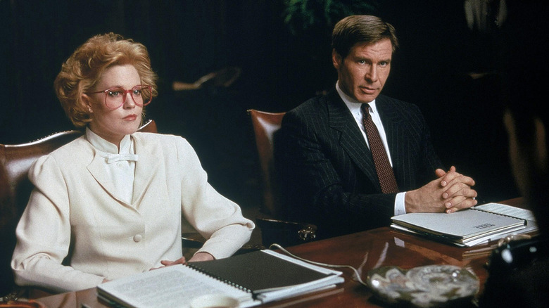 Melanie Griffith and Harrison Ford in business meeting