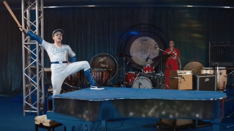 Elton John holds baseball bat