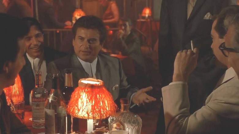Tommy stares accuising at his friends in a restaurant