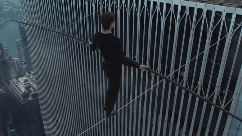 Joseph Gordon-Levitt as Philippe Petit walking on a tightrope between the World Trade Center Twin Towers in The Walk