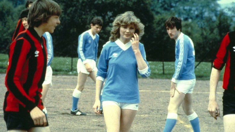Dorothy in soccer uniform amidst the male players