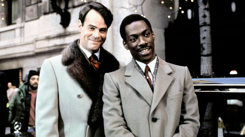 Dan Aykroyd and Eddie Murphy smile triumphantly