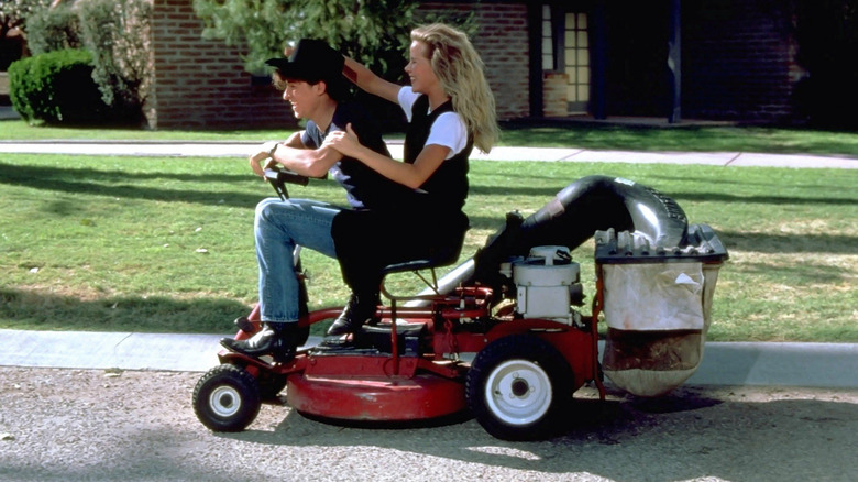 Ronald (Patrick Dempsey) and Cindy (Amanda Peterson) riding a lawnmower in Can't Buy Me Love