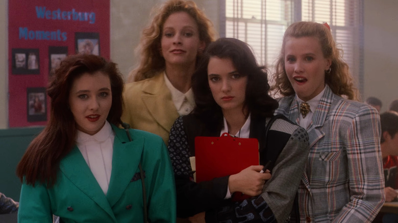 The Heathers (Shannen Doherty, Lisanne Falk, and Kim Walker) and Veronica (Winona Ryder) in lunchroom in Heathers