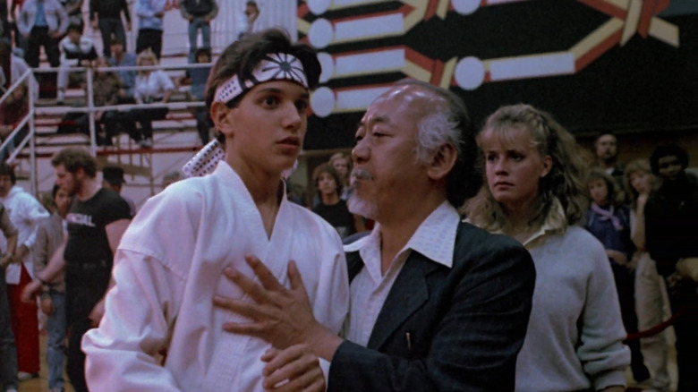 Daniel (Ralph Macchio) terrified at karate championship with Mr. Miyagi (Pat Morita) in The Karate Kid