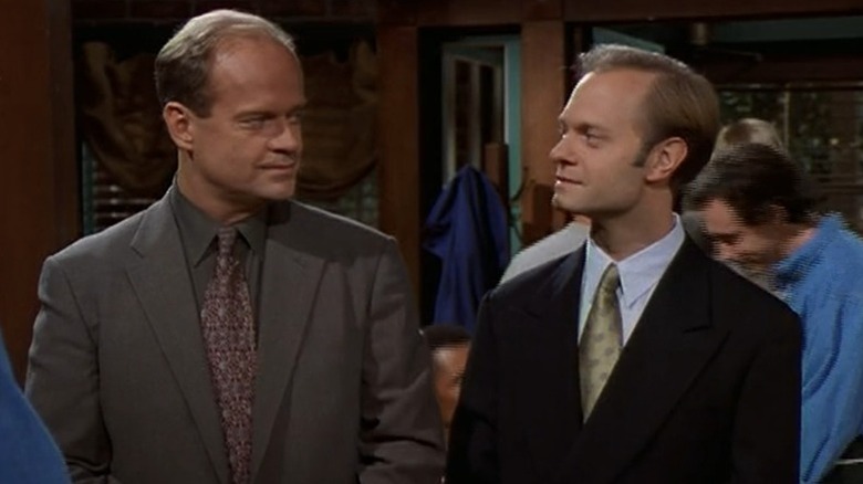 Frasier Crane (Kelsey Grammer) and Niles Crane (David Hyde Pierce) look at each other knowingly in Frasier