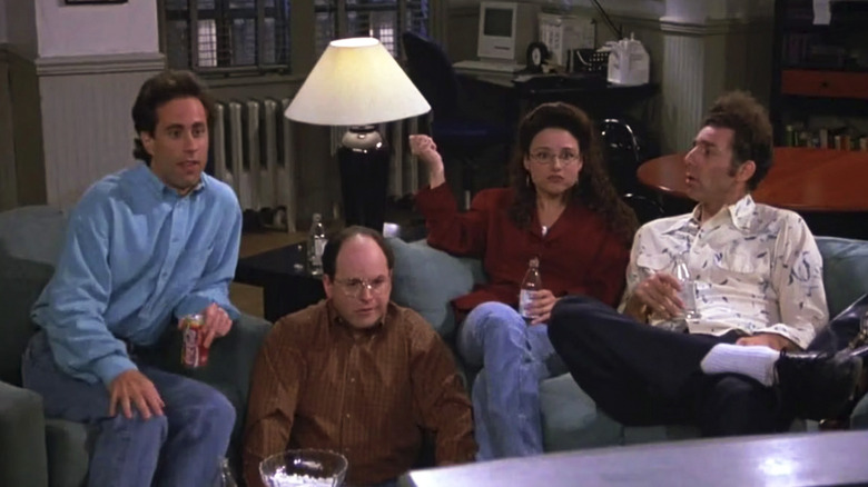 Jerry, George, Elaine, and Kramer sit in Jerry's living room watching TV in Seinfeld