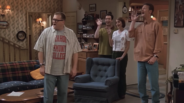 Oswald Lee Harvey (Diedrich Bader), Drew Carey, and Lewis Kiniski (Ryan Stiles) bid farewell to someone off camera on The Drew Carey Show