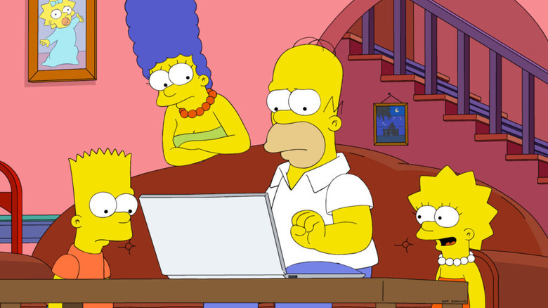 Bart Simpson (Nancy Cartwright), Marge Simpson (Julie Kavner), and Lisa Simpson (Yeardley Smith) watch Homer Simpson (Dan Castellaneta) type on a laptop in The Simpsons