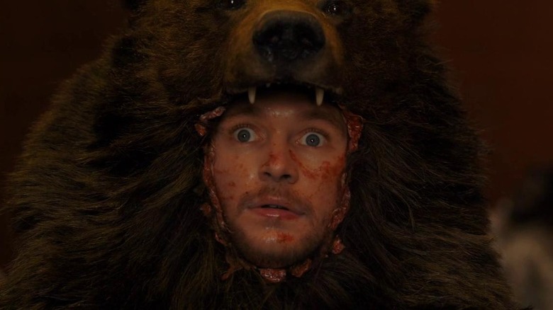 Jack Reynor as Christian in Midsommar, stitched into a bearskin, face bloody and eyes wide in fear