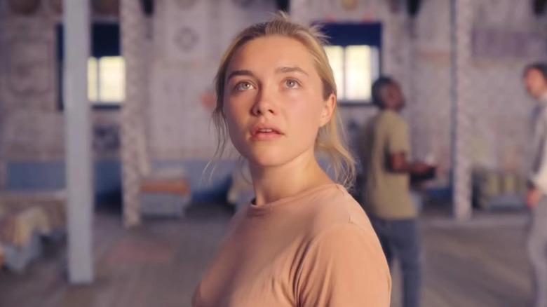 Dani (Florence Pugh) looks at bizarre artwork in Midsommar