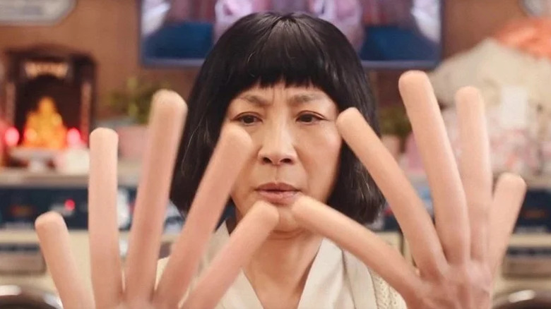 Michelle Yeoh's Evelyn in the dimension where everyone has hot-dog fingers, part of Everything Everywhere All at Once's multiverse