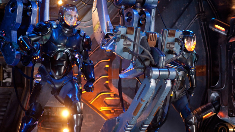 Charlie Hunnam and Rinko Kikuchi as Raleigh Becket and Mako Mori, piloting a robot in Pacific Rim