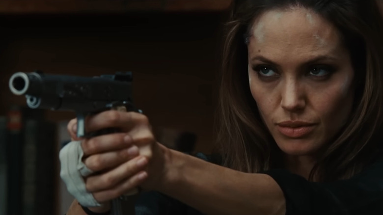 Angelina Jolie as Fox, aiming a pistol in Wanted