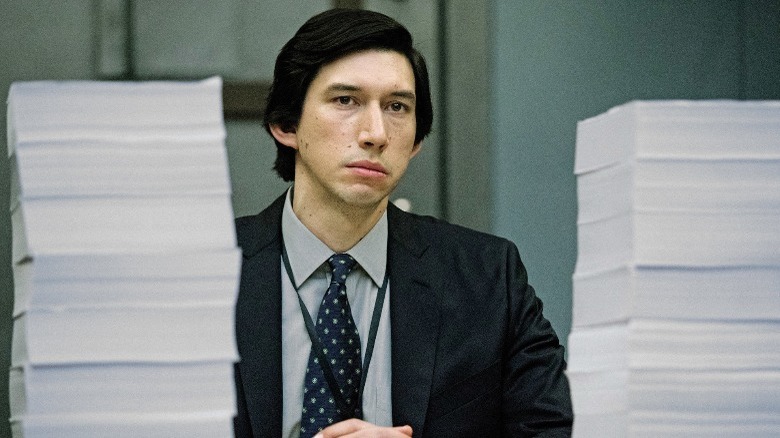 Daniel Jones sitting between stacks of paper